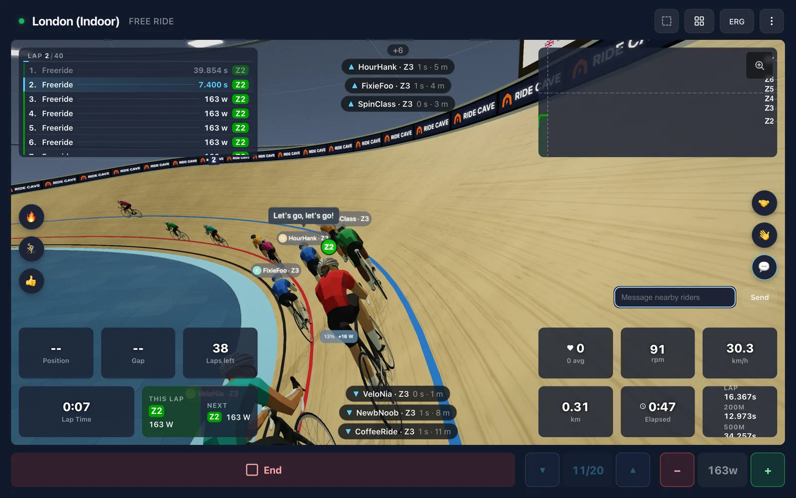 A bot calling out in a paceline on a 3D velodrome, with the quick chat buttons and message box on screen